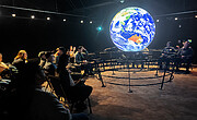 Project ASTRO teachers and astronomers enjoying a Science on a Sphere show in the McMath Pierce Solar Telescope.