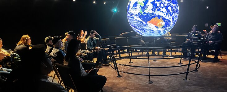 Project ASTRO teachers and astronomers enjoying a Science on a Sphere show in the McMath Pierce Solar Telescope.