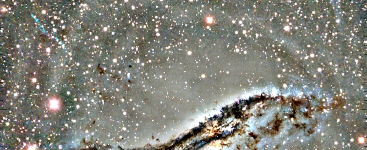 Arc of Blue Stars a Lingering Sign of Shredded Dwarf Galaxy
