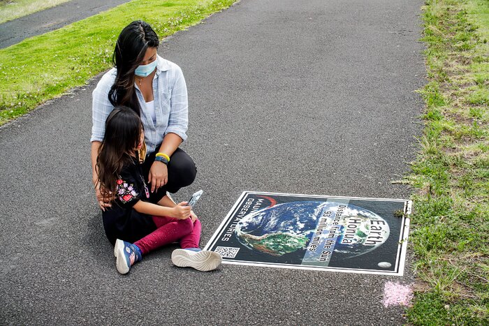 Mother and child participate in the Waimea Solar System walk