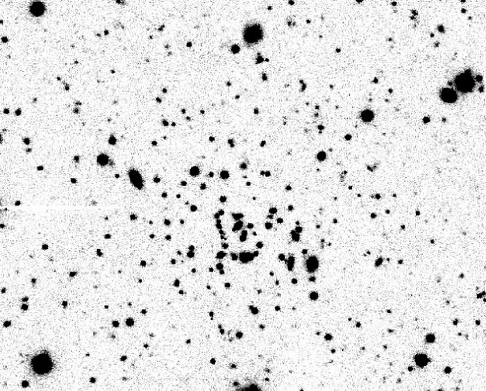 Far from home: wayward cluster is both tiny and distant