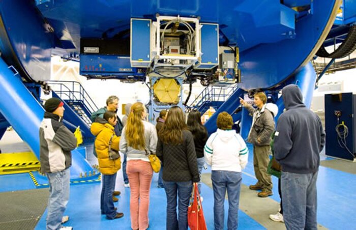 Staff family tour participants visit the telescope