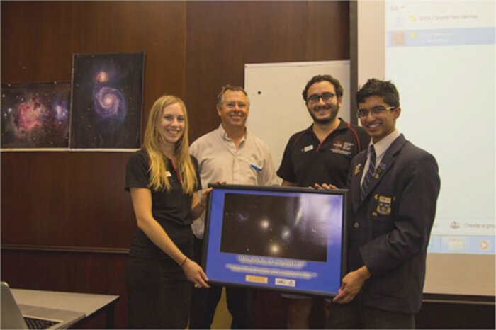 Student winner and mentors with the winning image